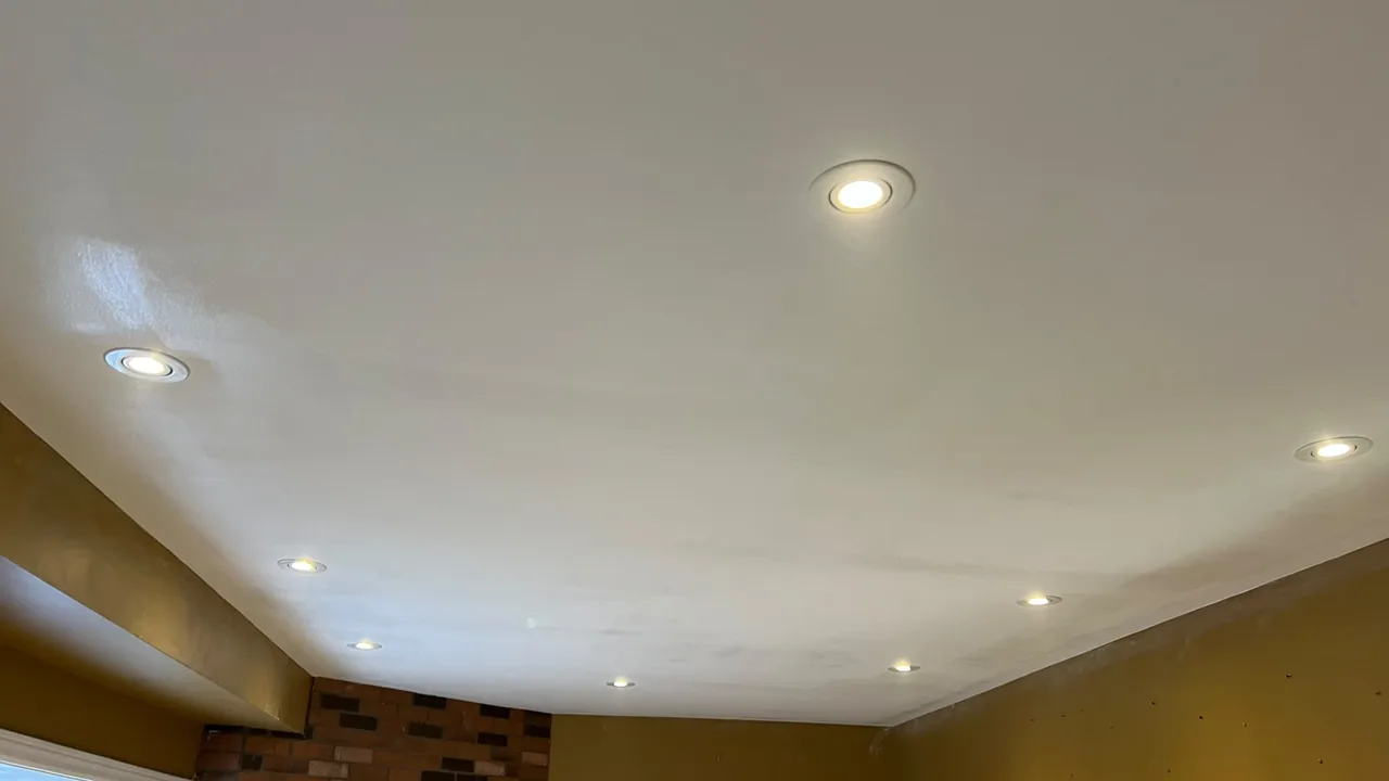 Repaired smooth ceiling after damage repair and popcorn removal